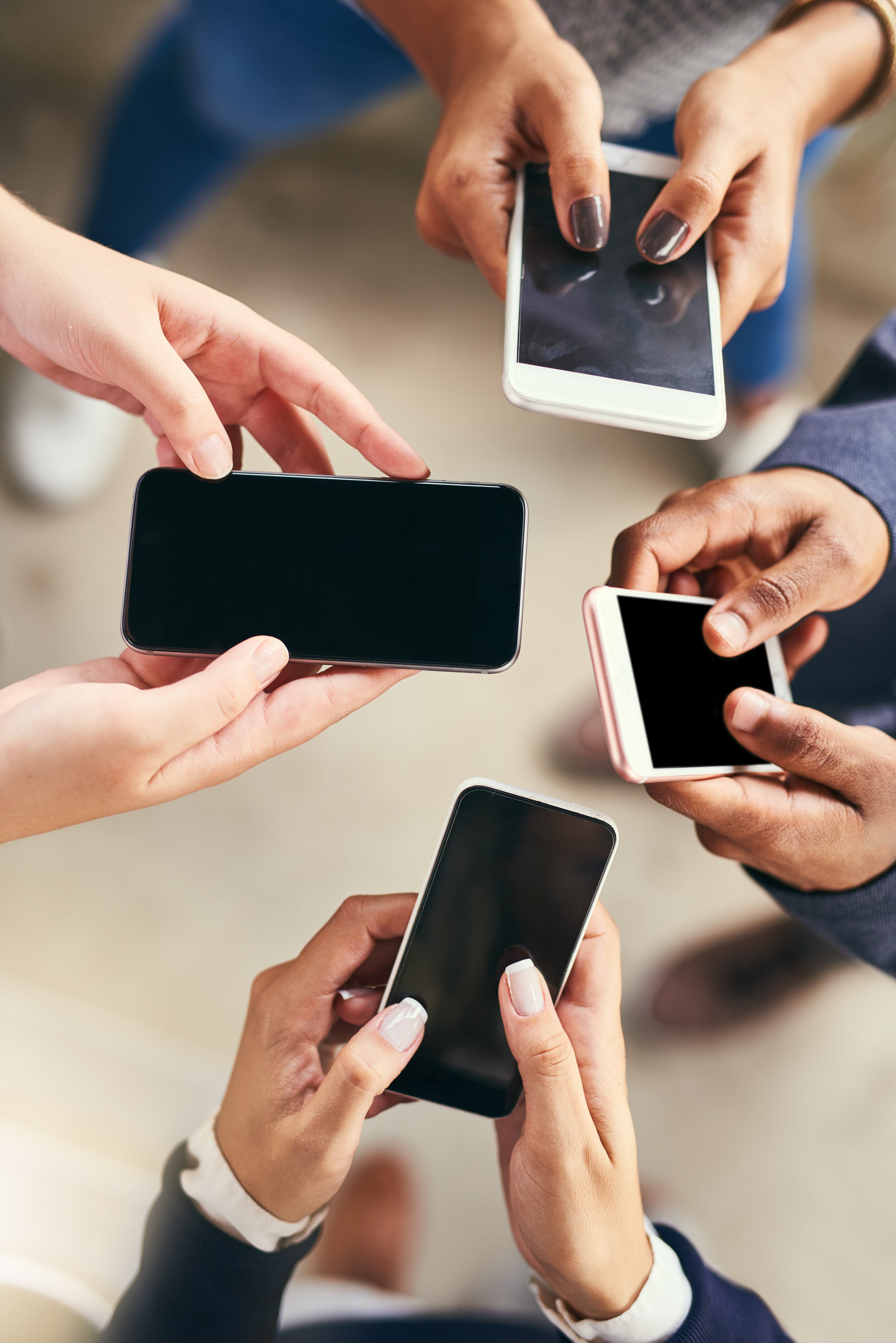 Image of hands holding cell phones